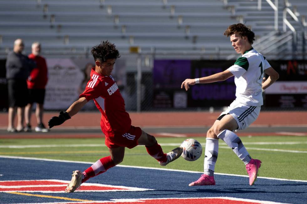 Coronado goaltender Logan Pierce kicks the ball away after Palo Verde forward Evan Odle (14) at ...