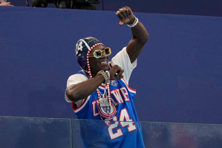 Flavor Flav cheers the U.S. team during a women's water polo Group B preliminary match between ...