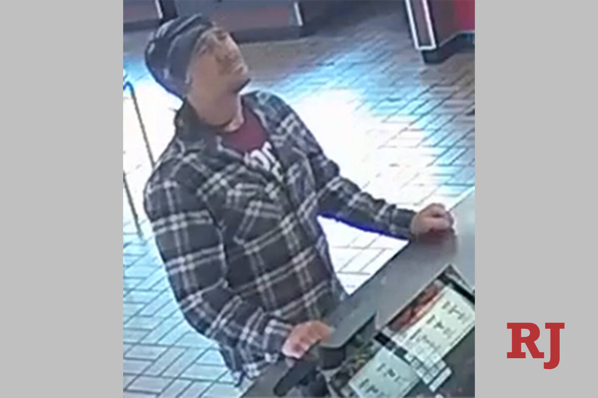 A surveillance photo of a suspect wanted in a string of armed robberies over the past three mon ...