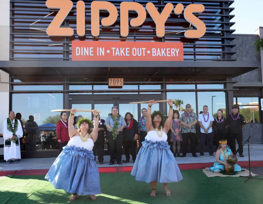 Chyeanne Akima, left, and Leanne Lafua dance as Kanani Cadaoas, all of Las Vegas, sings during ...