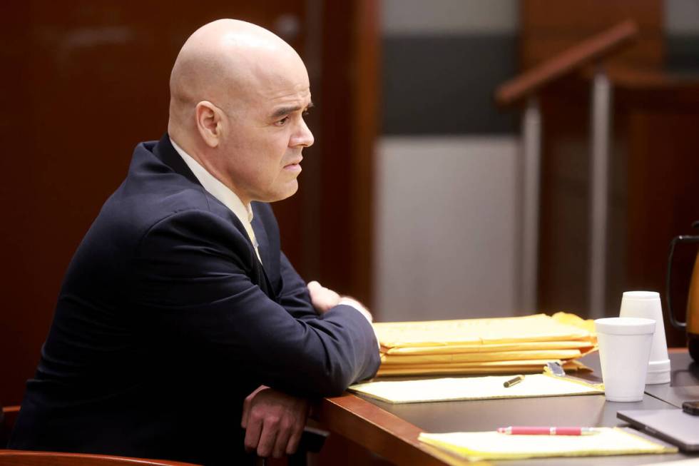 Robert Telles waits at the defense table in court as his attorneys meet with the judge at the b ...