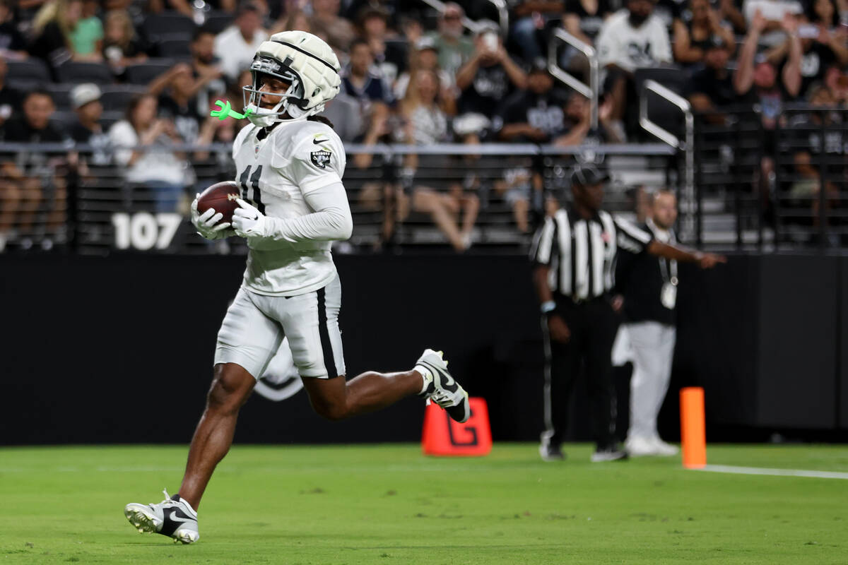 Raiders wide receiver Tre Tucker (11) runs in a touchdown during an NFL football practice at Al ...