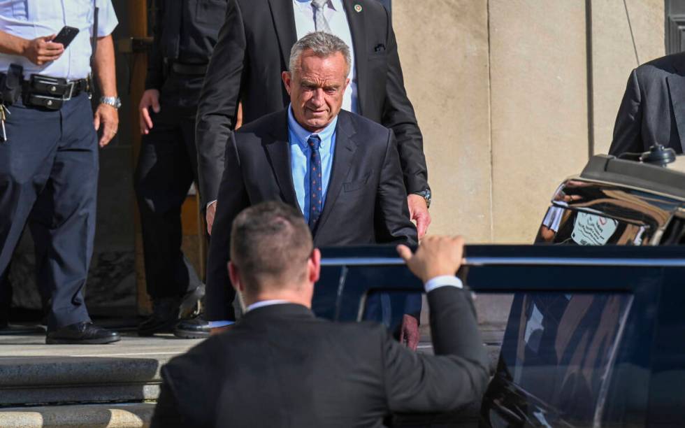 FILE - Independent presidential candidate Robert F. Kennedy Jr., top, leaves after giving testi ...