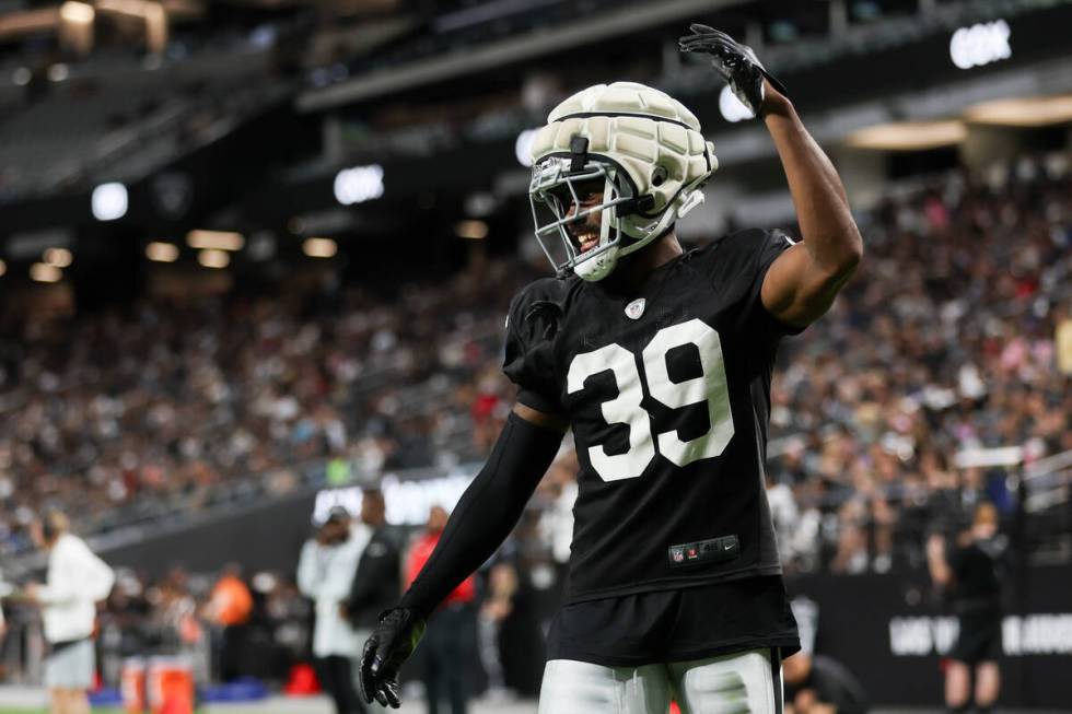 Raiders cornerback Nate Hobbs (39) pumps up the crowd during an NFL football practice at Allegi ...