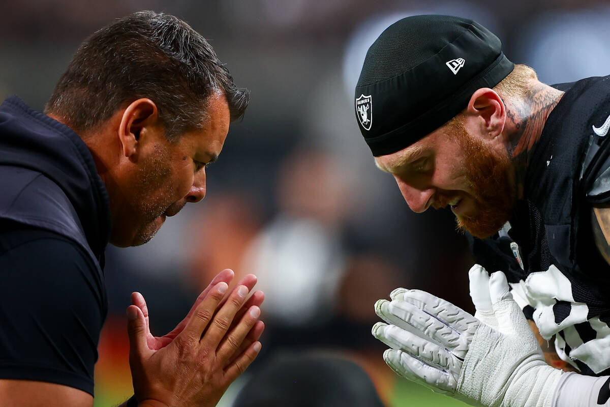 Raiders defensive end Maxx Crosby, right, bows to a coach during an NFL football practice at Al ...