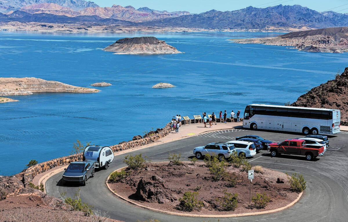 A tour bus drops off passengers to view Lake Mead from the Lakeview Overlook as new projections ...