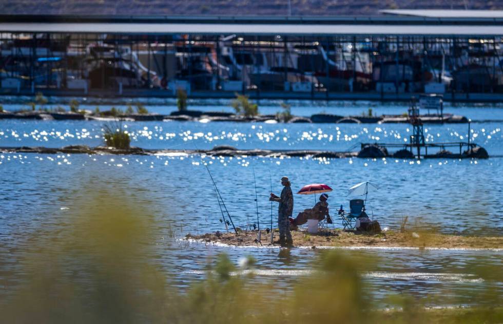 Men fish off of the shore near the Hemenway Harbor boat launch on Lake Mead Thursday, Aug. 15, ...