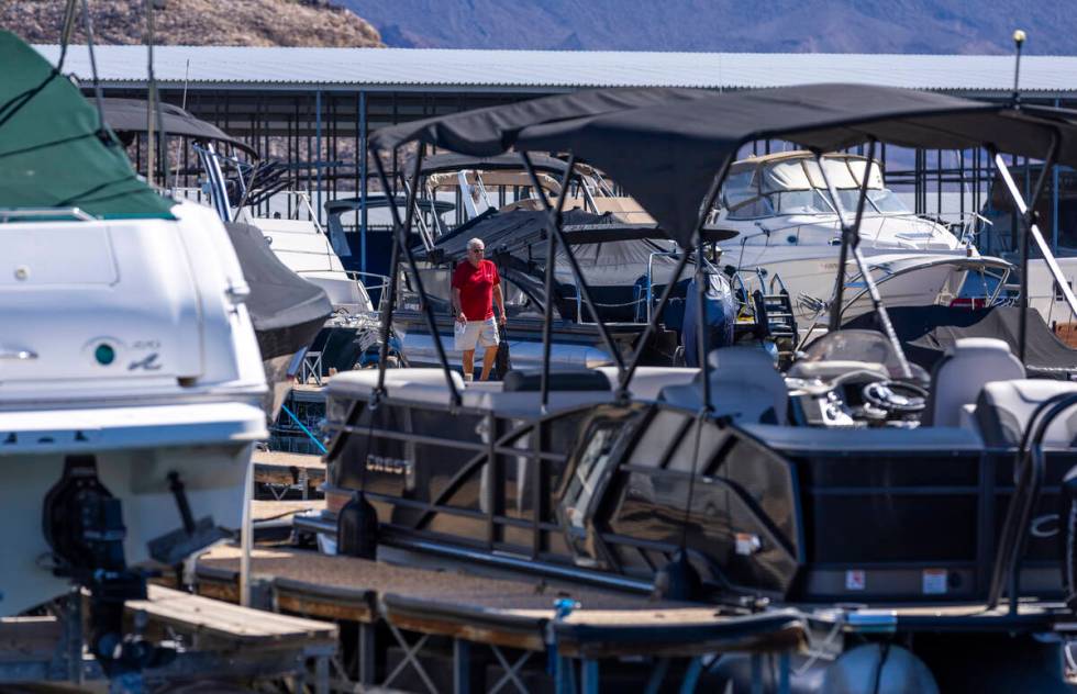 A man walks across the Lake Mead Marina docks Thursday, Aug. 15, 2024, near Boulder City. New ...