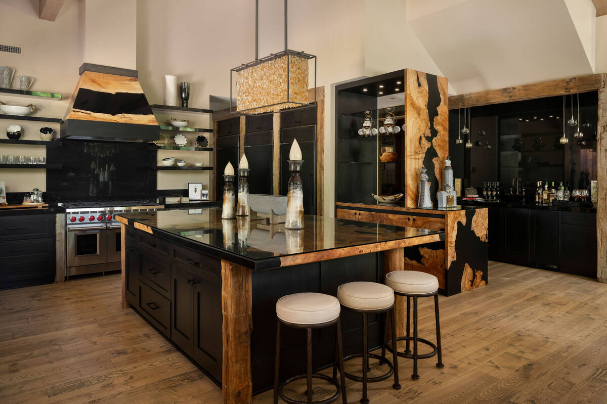 The kitchen is tailored to maximize every inch of space with high-end appliances, black cabinet ...