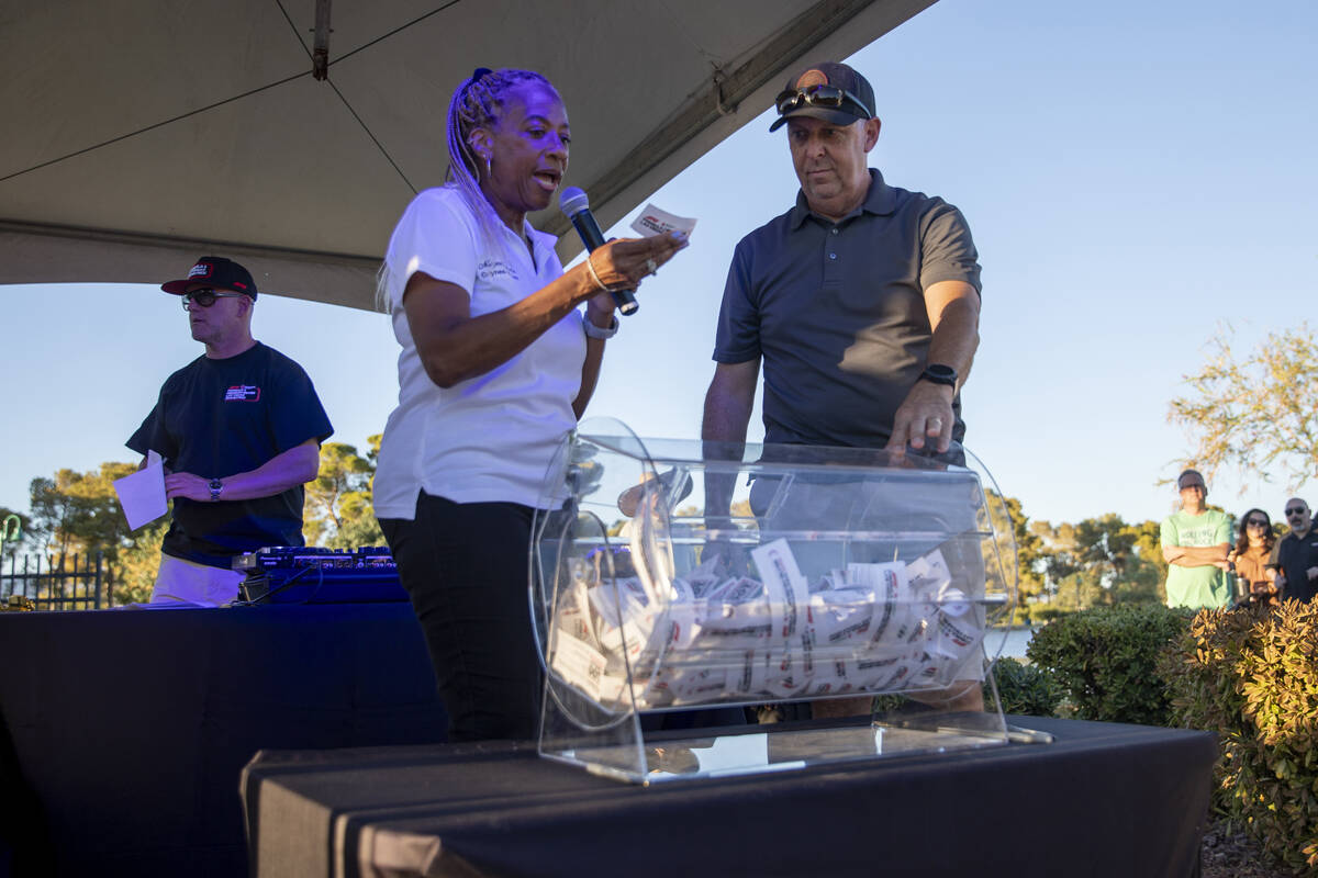 North Las Vegas Mayor Pamela Goynes-Brown, left, and Councilman Scott Black, right, draw names ...