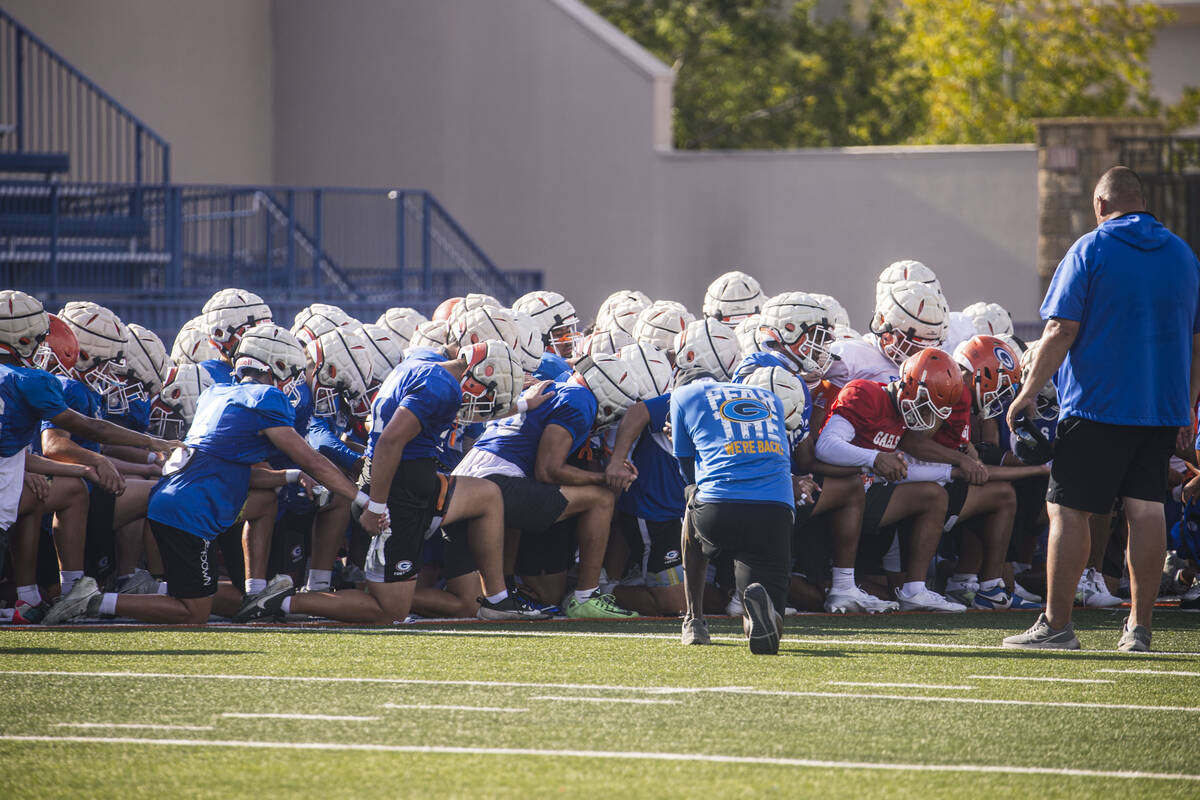 Bishop Gorman football players huddle at the end of practice on Thursday, Aug. 8, 2024, in Las ...