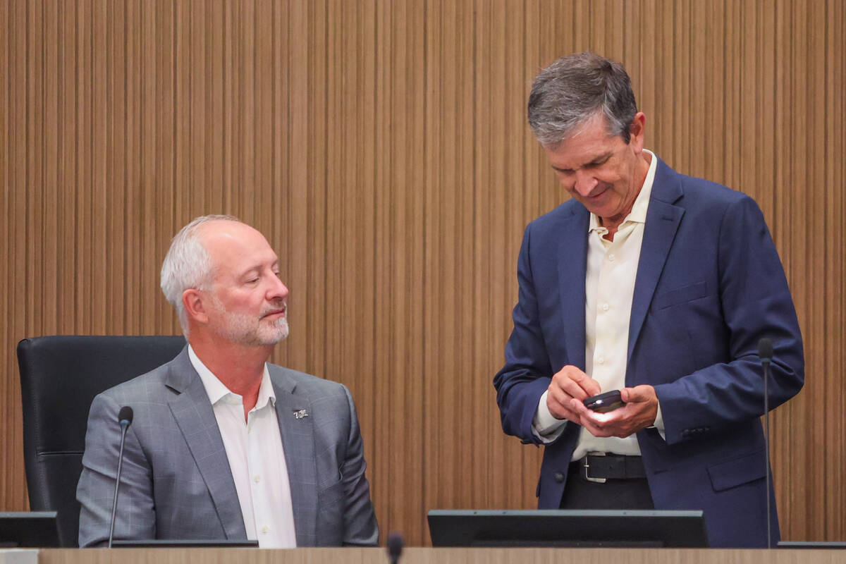 Las Vegas Stadium Authority chairman Steve Hill, left, converses with board member Bob Yosaitis ...