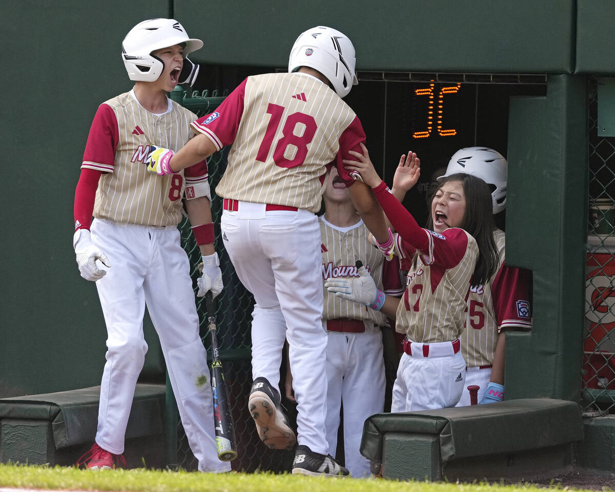 Paseo Verde's Wyatt Erickson (18) is welcomed at the dugout steps after driving in two runs wit ...