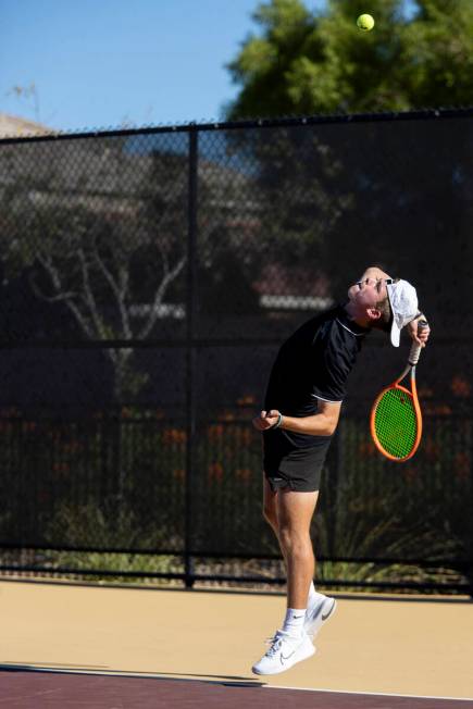 Faith Lutheran sophomore David Gluth III serves the ball during the tennis matches against The ...