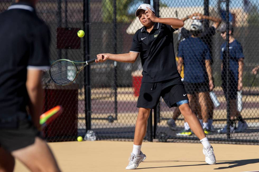 Faith Lutheran freshman Tyson Young competes during the tennis matches against The Meadows at F ...