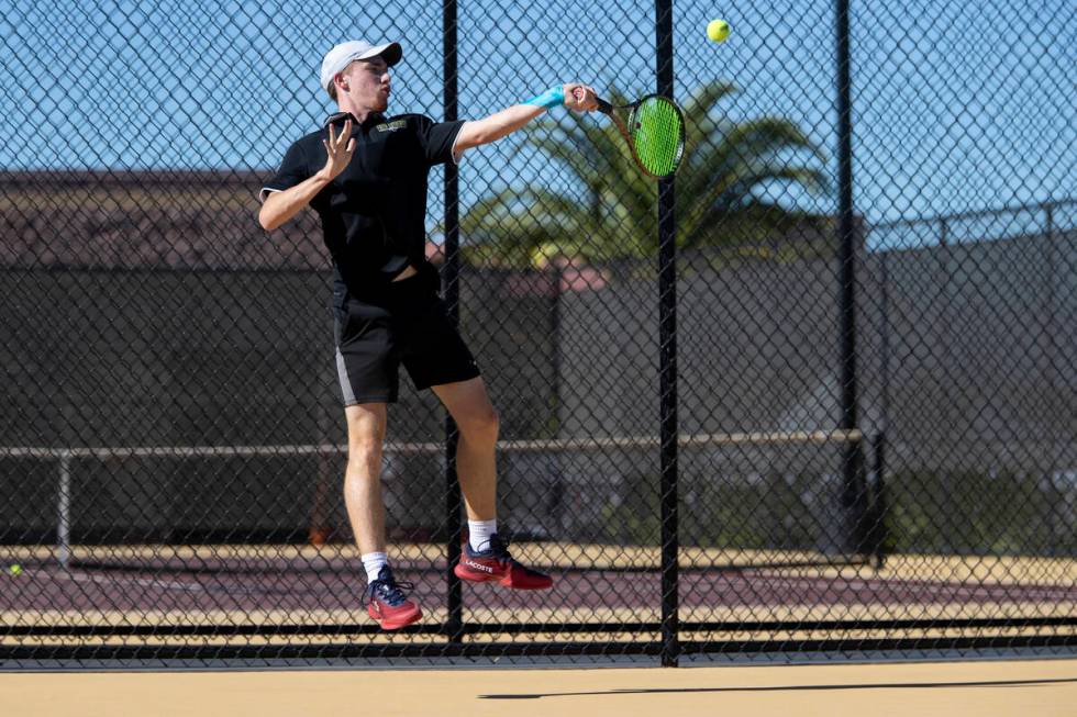 Faith Lutheran senior Nolan Dubay competes during the tennis matches against The Meadows at Fai ...