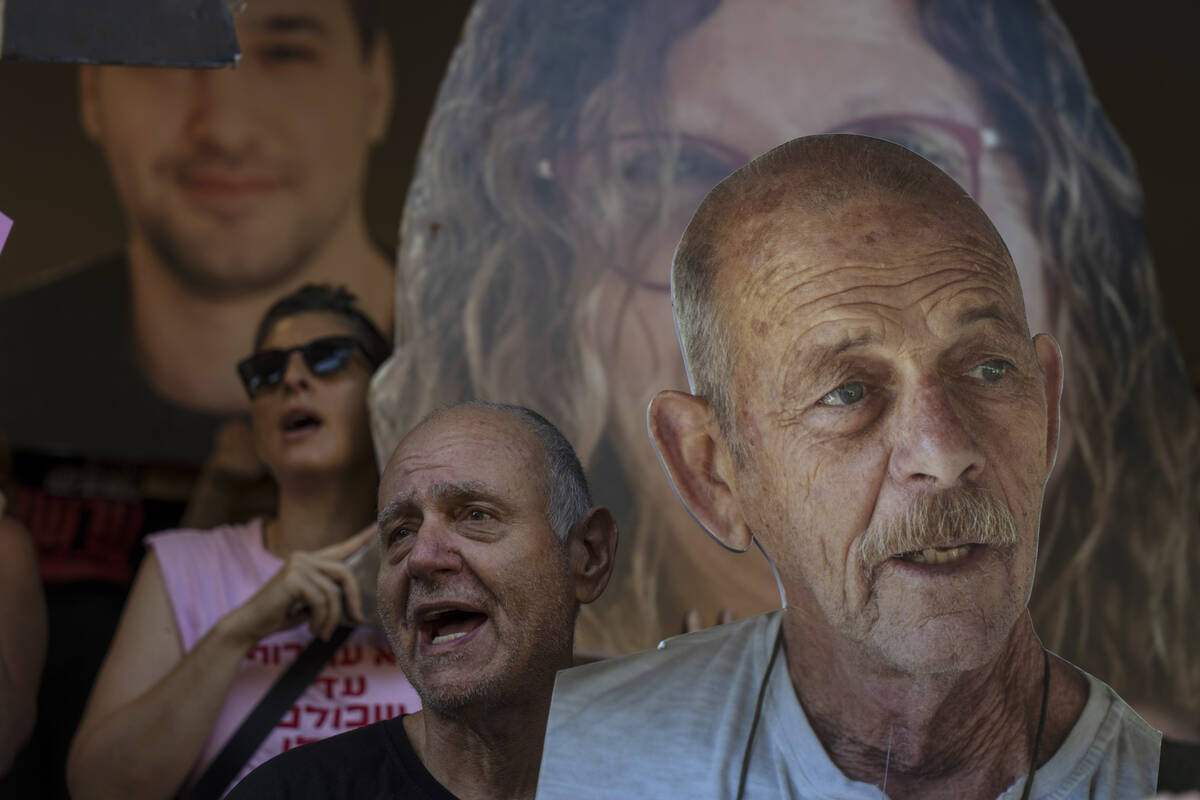 Relatives and supporters of Israeli hostages held by Hamas in Gaza hold photos of their loved o ...