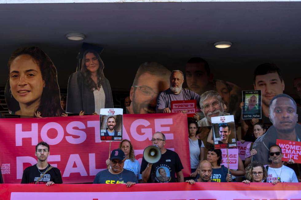 Relatives and supporters of Israeli hostages held by Hamas in Gaza hold photos of their loved o ...