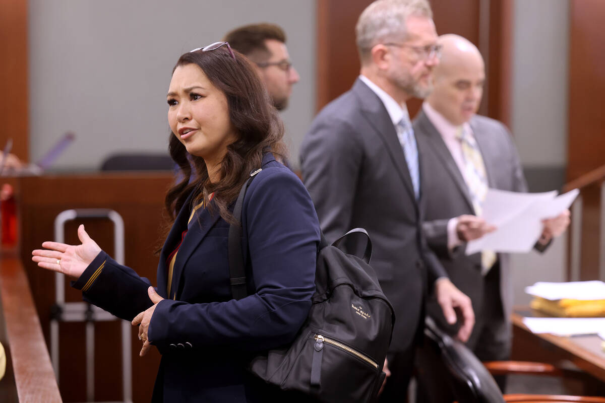 Robert Telles, right, talks with one of his attorneys, Robert Draskovich, as his former employe ...