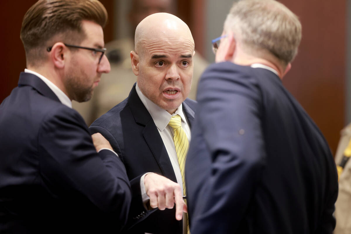 Robert Telles talks to his attorneys Michael Horvath., left, and Robert Draskovich in the court ...