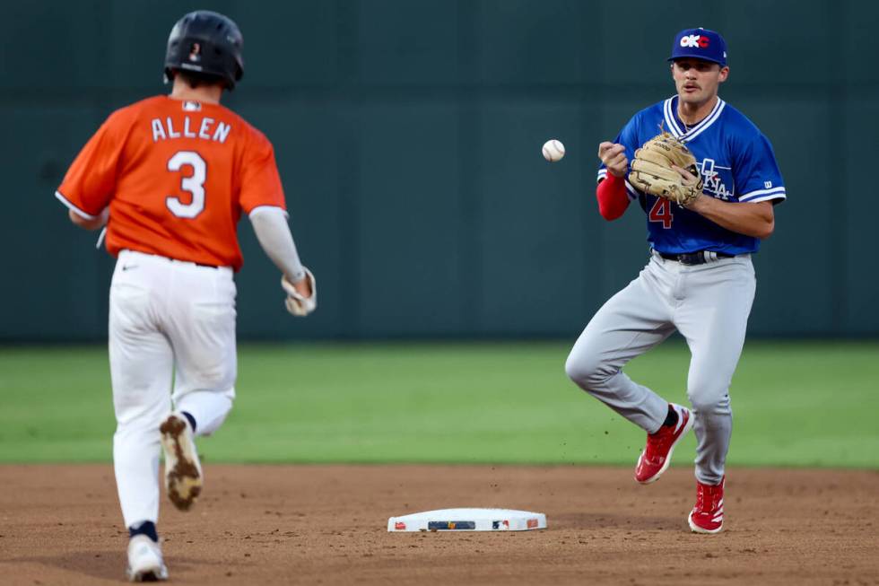 Oklahoma City infielder Austin Gauthier (4) fumbles a catch while Las Vegas Aviators infielder ...