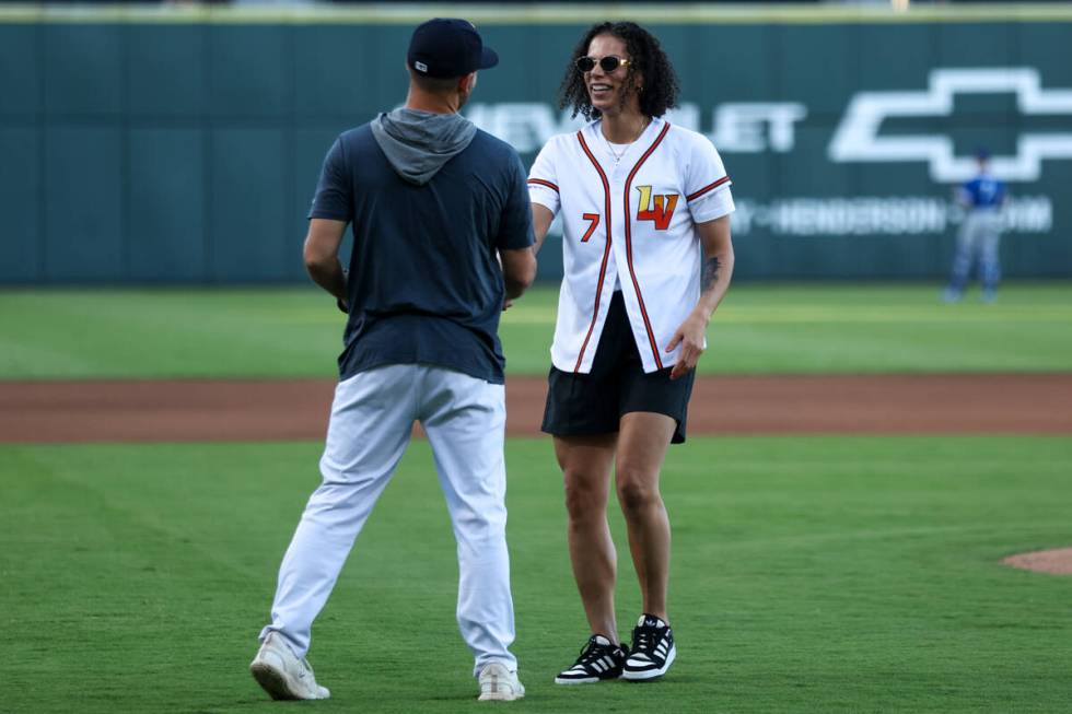 Las Vegas Aces forward Alysha Clark is congratulated after throwing the first pitch during a Mi ...