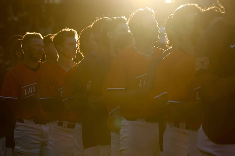 The Las Vegas Aviators stand during the national anthem before a Minor League Baseball game aga ...