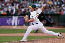 Oakland Athletics pitcher Grant Holman throws to a San Francisco Giants batter during the eight ...