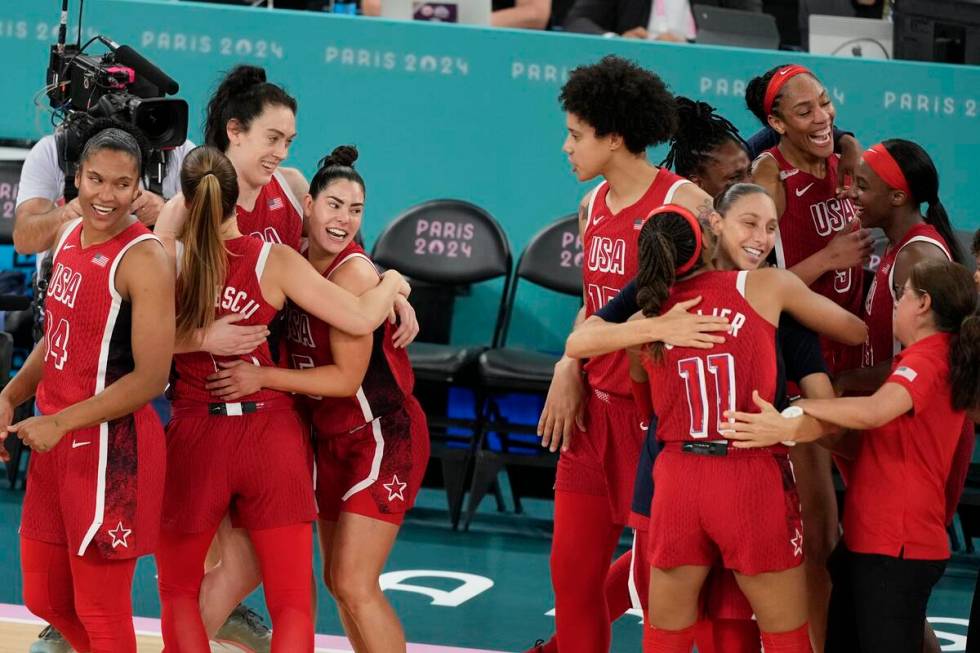 The United States team celebrates after a women's gold medal basketball game at Bercy Arena at ...