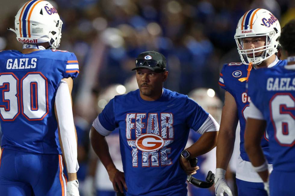 Bishop Gorman head coach Brent Browner brings his team into a timeout during the first half of ...