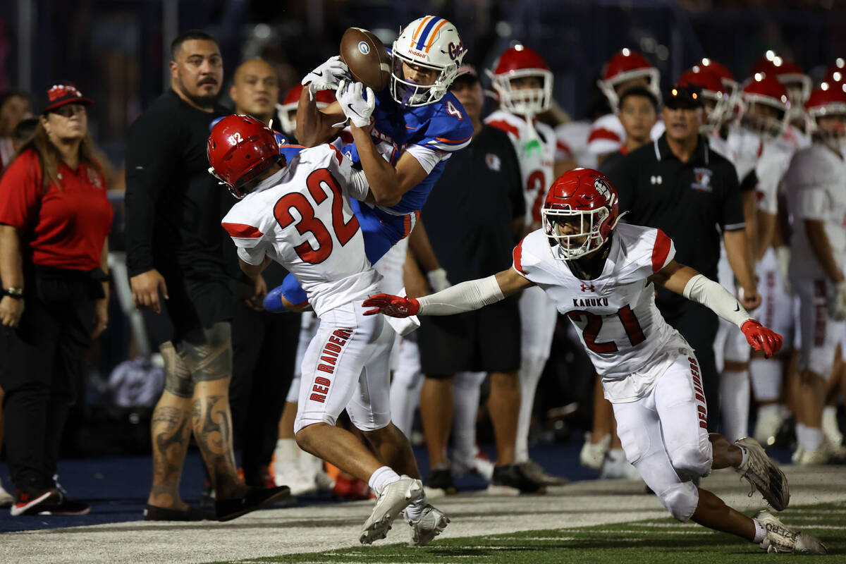 Bishop Gorman wide receiver Kaina Watson (4) catches a pass out-of-bounds while Kahuku defensiv ...