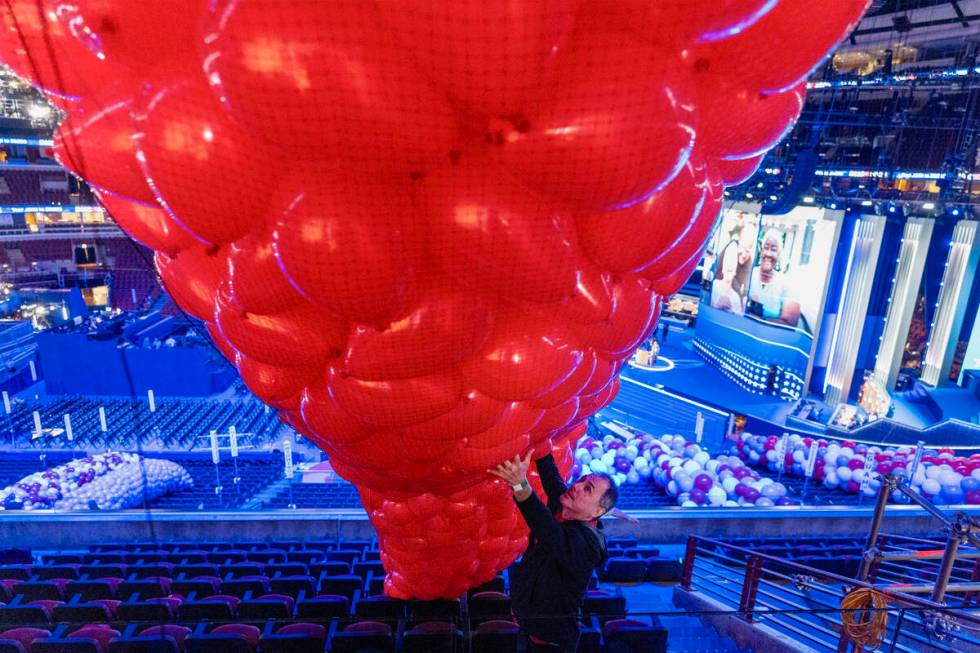 Tony Popelka guides a bag of balloons as preparations are made before the upcoming Democratic N ...