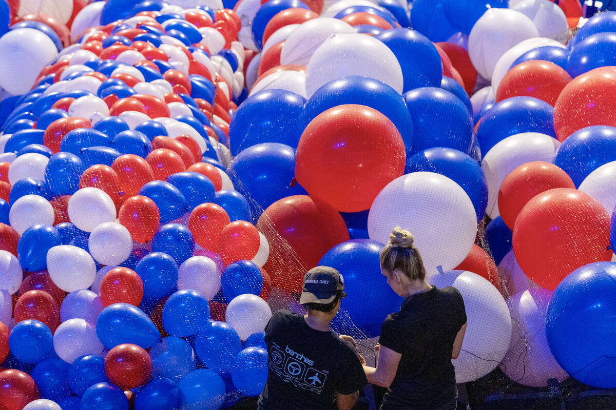 Balloons are staged to be raised to the ceiling as preparations are made before the upcoming De ...