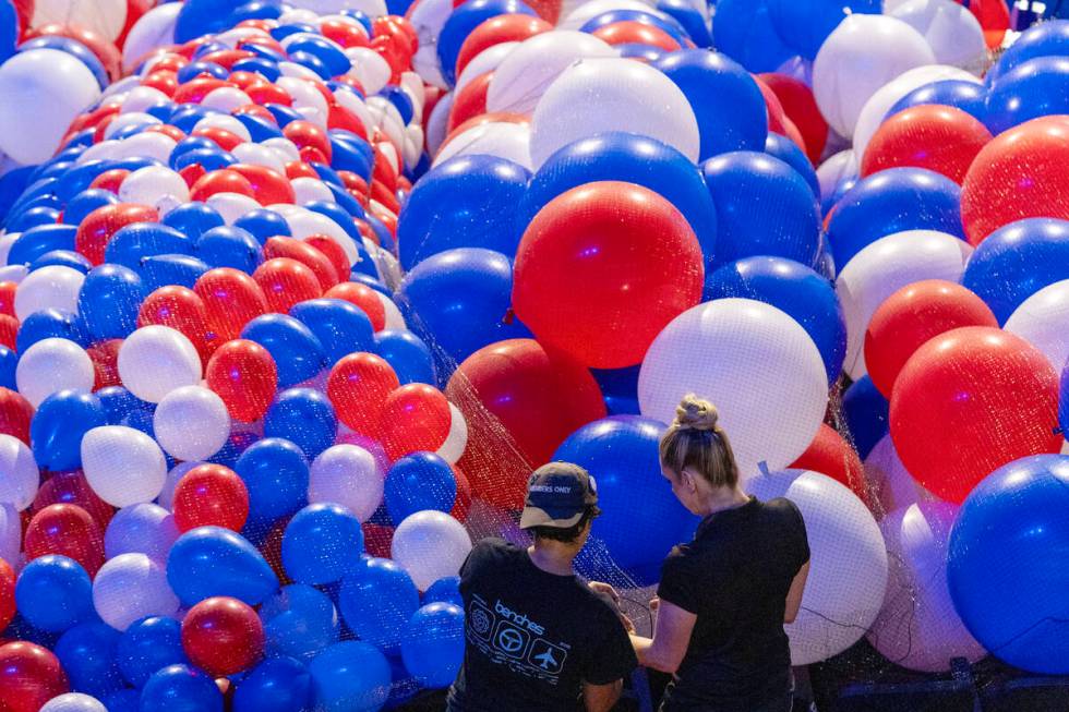 Balloons are staged to be raised to the ceiling as preparations are made before the upcoming De ...