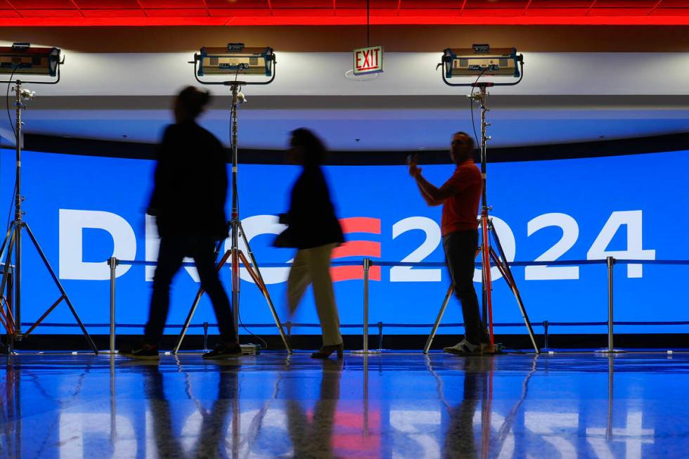 People walk past a display inside the United Center as preparations are made for next week's 20 ...