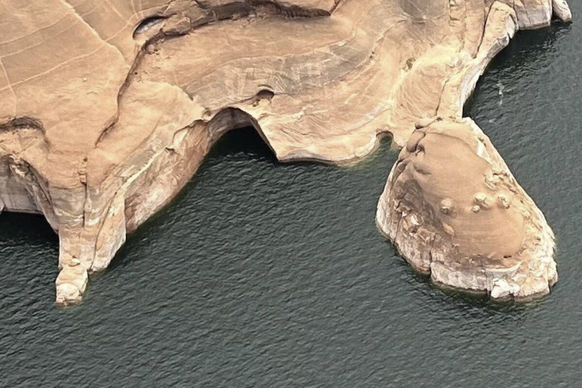 This photo provided by the National Park Service shows the Double Arch, center, after the colla ...