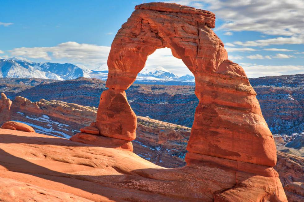 Delicate Arch in Arches National Park Utah with the snow capped Lasalle Mountains in the backgr ...