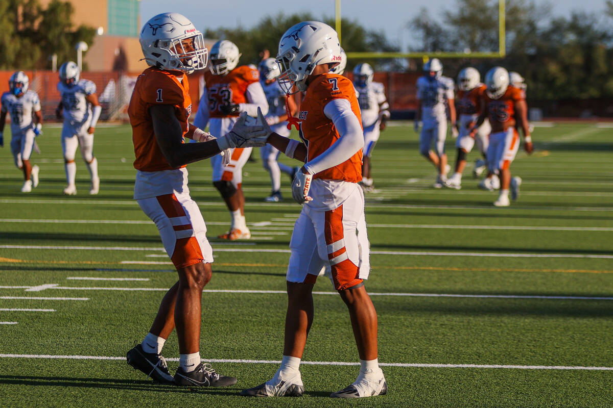 Legacy teammates Dominic Oliver (1) and Jordan Thompson-Woods (7) celebrate a touchdown by Oliv ...