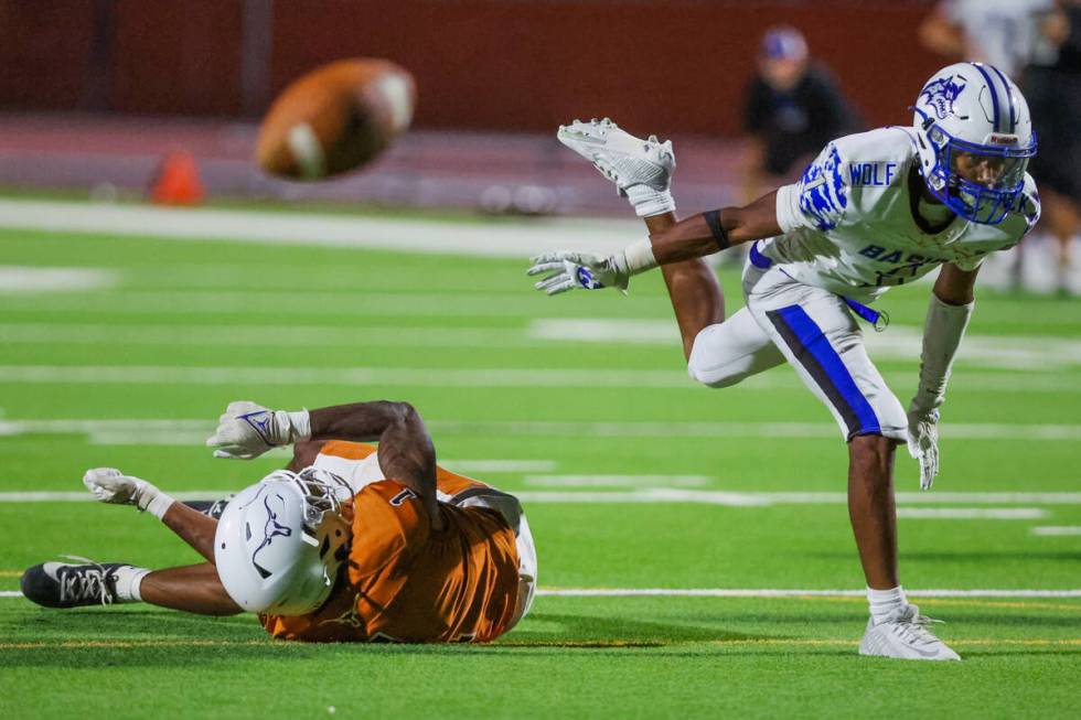 Legacy wide receiver Dominic Oliver (1) goes down as Donovan Glover (1) covers him during a foo ...