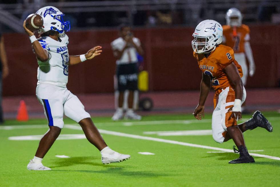 Basic quarterback Jayveon Rose (9) passes the ball as Legacy defensive end Derrick Marshall (2) ...