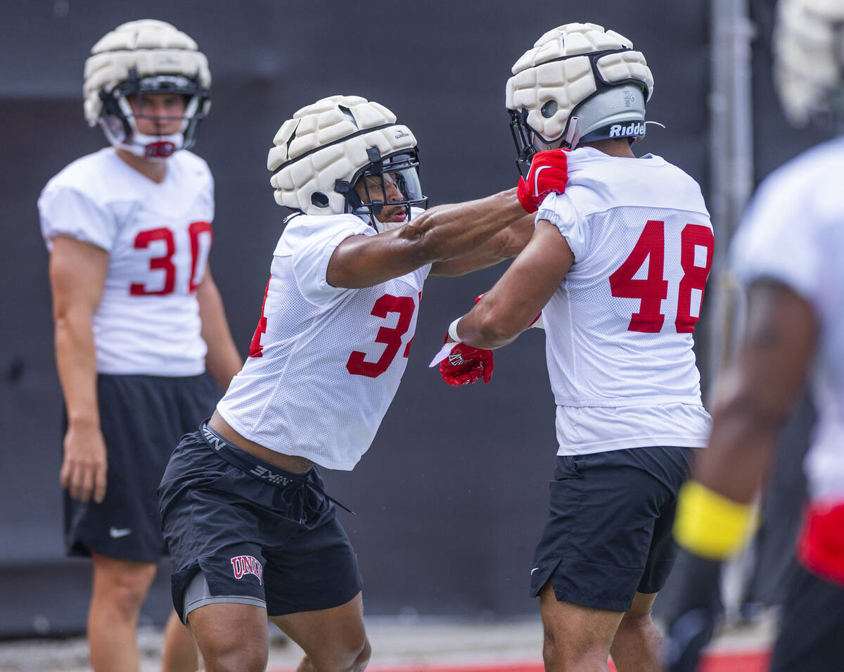 UNLV linebacker Tyray O'Dell (34) makes contact with linebacker Halatoa Tai (48) during the fir ...