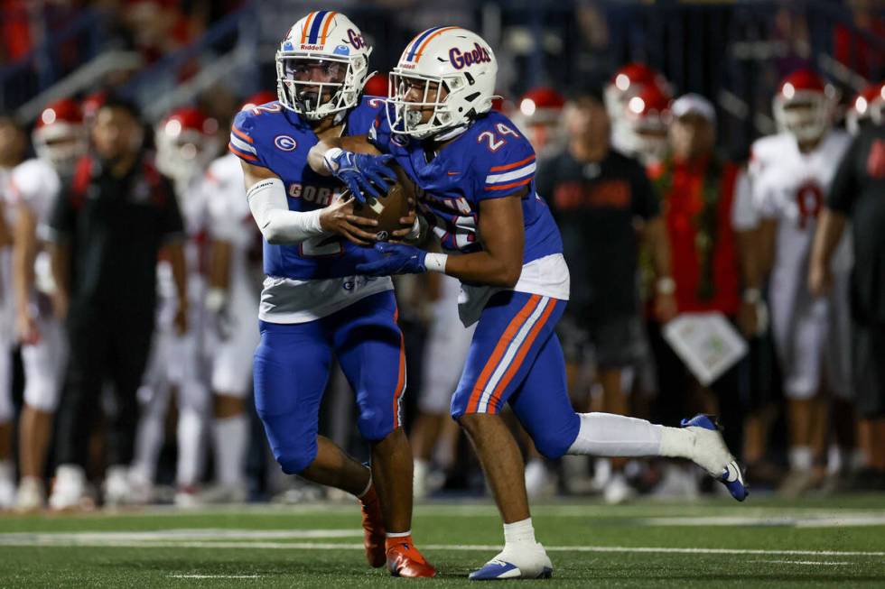 Bishop Gorman quarterback Melvin Spicer IV (2) hands the ball off to running back Myles Norman ...