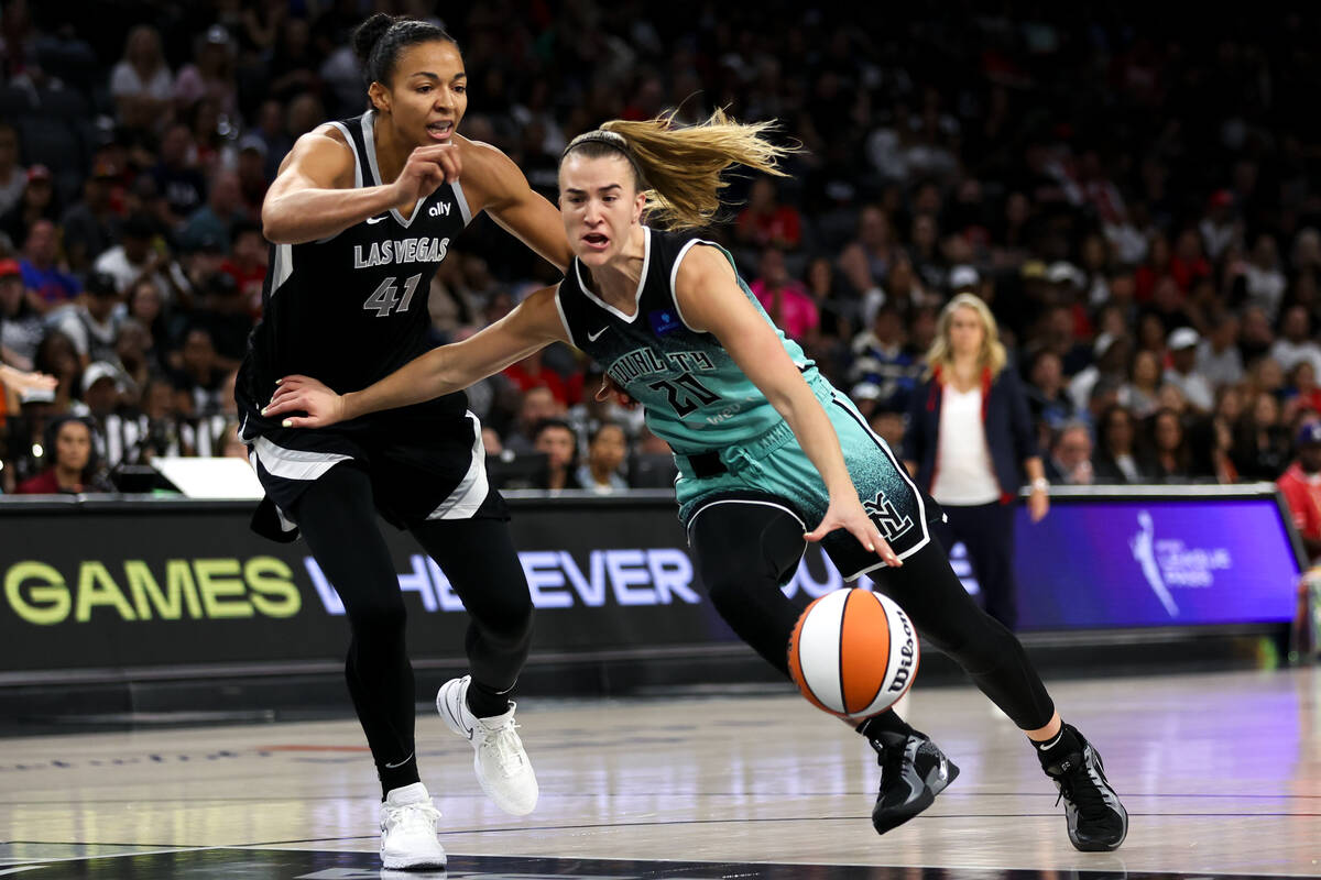 New York Liberty guard Sabrina Ionescu (20) drives toward the hoop against Las Vegas Aces cente ...