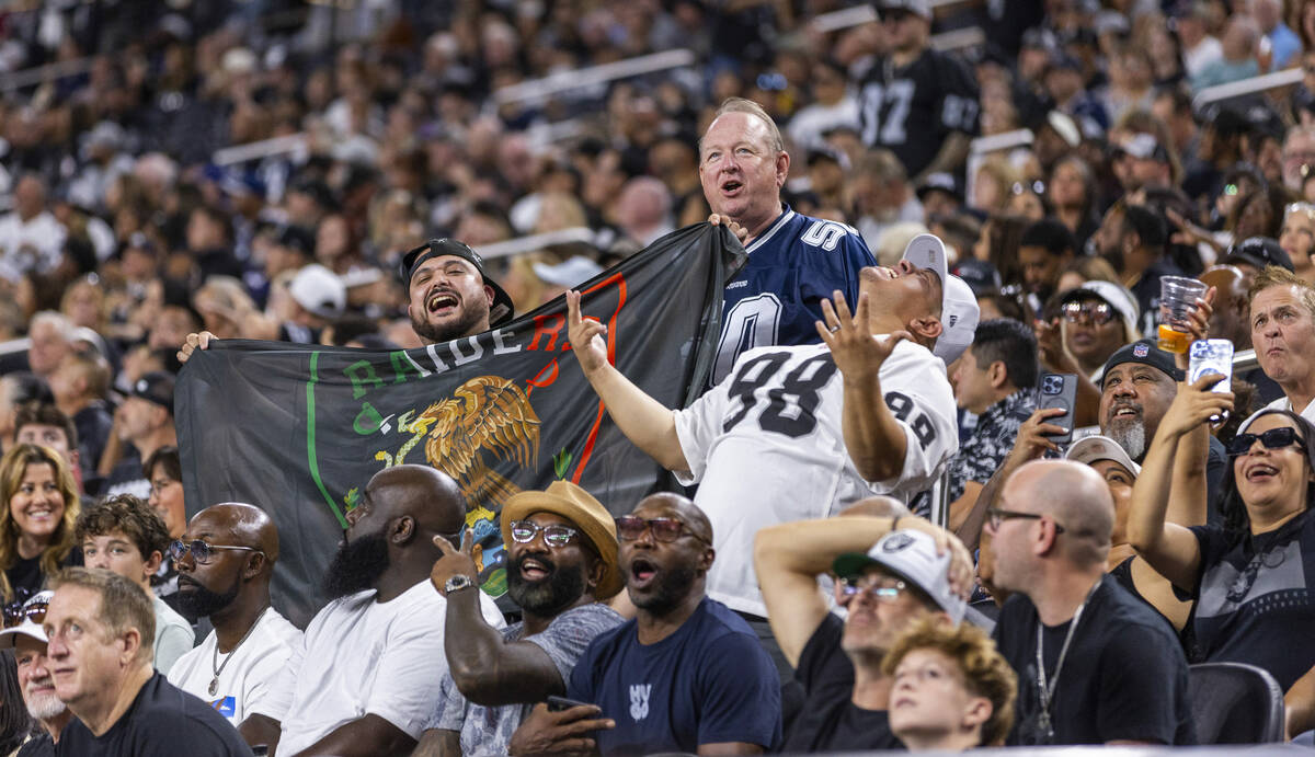 Raiders fans get pumped up in the stands against the Dallas Cowboys during the first half of th ...