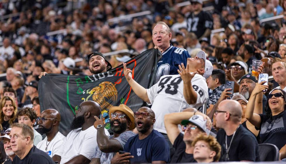 Raiders fans get pumped up in the stands against the Dallas Cowboys during the first half of th ...