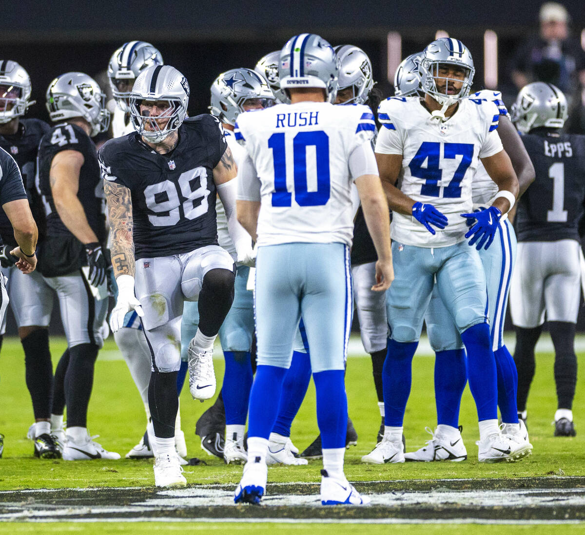 Raiders defensive end Maxx Crosby (98) celebrates a big stop on Dallas Cowboys quarterback Coop ...