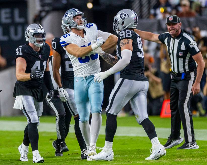 Raiders defensive end Maxx Crosby (98) tangles with Dallas Cowboys defensive tackle Justin Roge ...