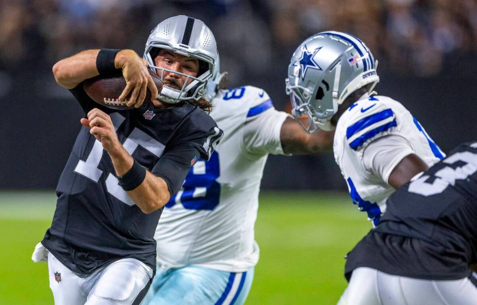 Raiders quarterback Gardner Minshew (15) looks for a yards on the run against the Dallas Cowboy ...