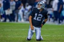 Raiders quarterback Aidan O'Connell (12) looks up from the turf after taken down by Dallas Cowb ...