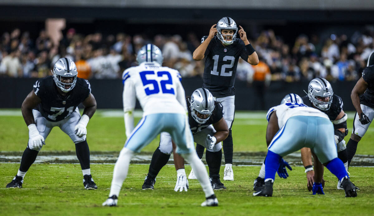 Raiders quarterback Aidan O'Connell (12) signals to teammates against the Dallas Cowboys during ...